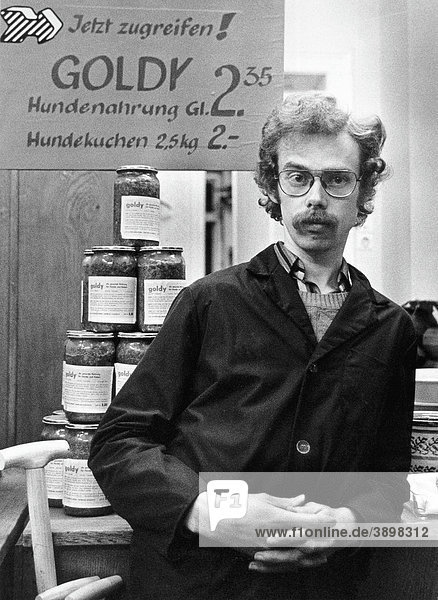 Shopkeeper and advertisement for dog food  East Germany  Europe  circa 1975