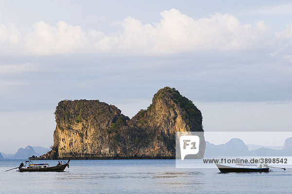 Longtail boat  fishing boat  limestone rock formations  Ko Hai or Koh Ngai island  Trang  Thailand  Asia