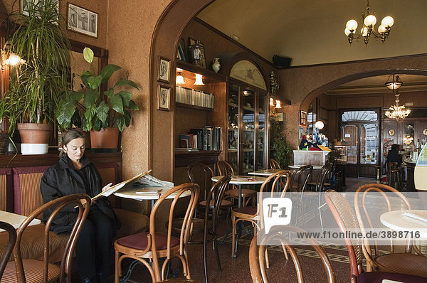 Woman reading a newspaper in the Caffe Poliziano  Montepulciano  Tuscany  Italy  Europe