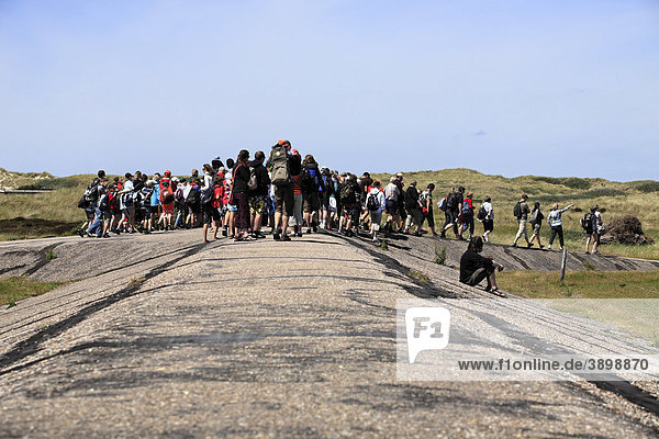 Group of tourists gathered at the dyke on island of Amrum  Schleswig-Holstein  Germany  Europe