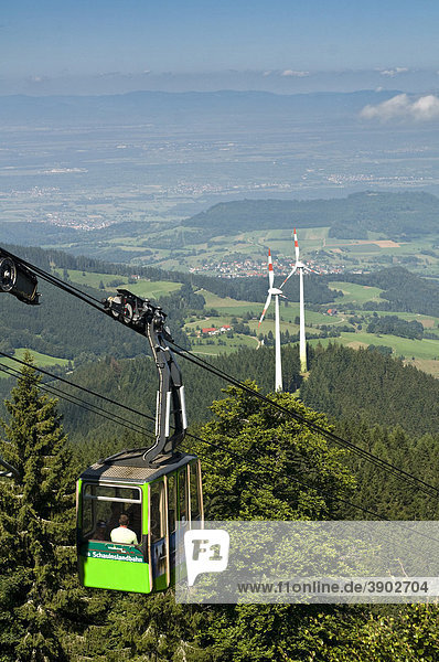 Gondola lift on Mt. Schauinsland with wind turbines  in the back Freiburg  Baden-Wuerttemberg  Germany  Europe