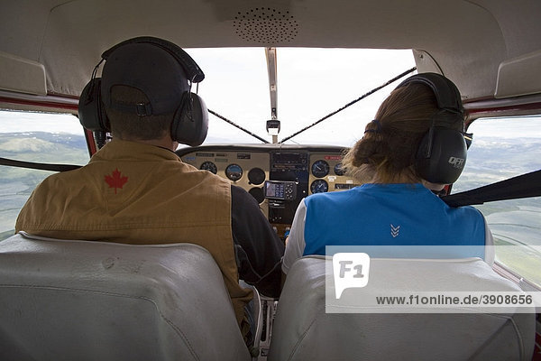 Pilot and co-pilot  cockpit of Float plane  bush plane  airborne  Cessna 180  Yukon Territory  Canada