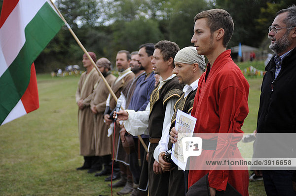 Award ceremony at the open Eocha European championship 09  mounted archery  with participants from all over the world  here the prize for old and new European Champion Christopher Nemethy  the Hungarian team is singing his national anthem  Trossenfurt  Franconia  Bavaria  Germany  Europe