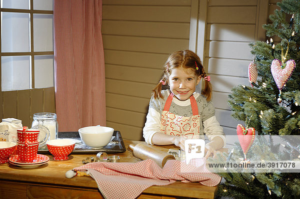Little girl baking Christmas cookies