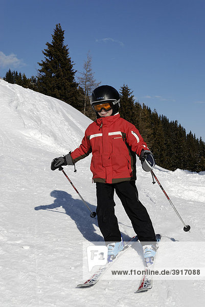 Child skiing  ski-run. alpine skiing with helmet  safety