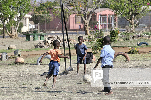 Three boys playing football  Cape Town  South Africa  Africa