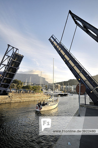 Yacht driving under a bascule bridge into the marina  Waterkant district  V & A Waterfront  Cape Town  South Africa  Africa