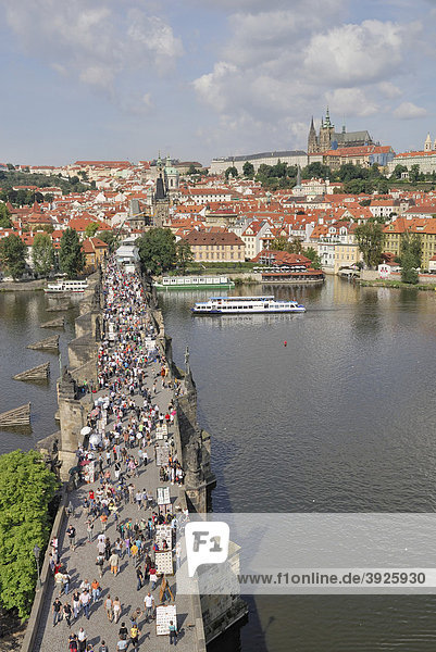 View from the Old Town Bridge Tower over the River Vltava  Charles Bridge with tourists  Prague Castle with St. Vitus Cathedral  Prague  Czech Republic  Europe