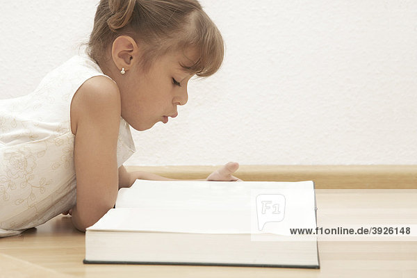 Six-year-old girl reading a book