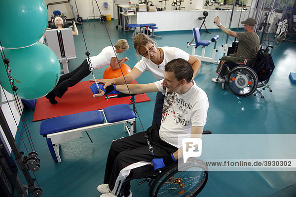 Patients during muscle strength training on various machines in a gym  physiotherapy  physical therapy in a neurological rehabilitation centre  Bonn  North Rhine-Westphalia  Germany  Europe