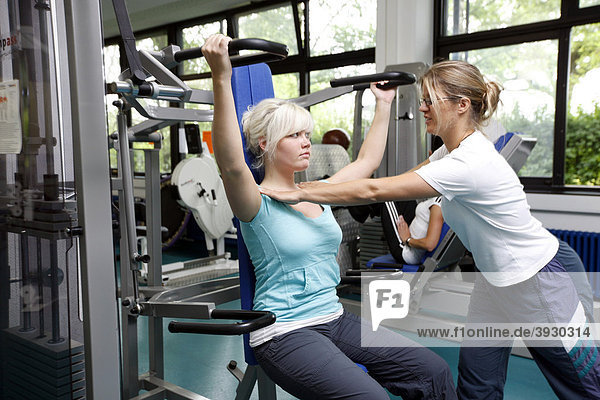 Patients during muscle strength training on various machines in the training room  physiotherapy in a neurological rehabilitation centre  Bonn  North Rhine-Westphalia  Germany  Europe