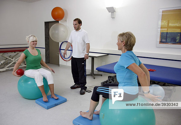 Physiotherapy exercises using exercise balls  physical therapy in a neurological rehabilitation centre  Bonn  North Rhine-Westphalia  Germany  Europe