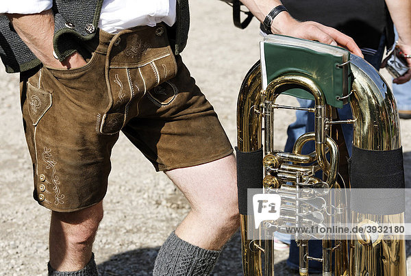 Man in traditional lederhosen leather pants leaning on a tuba  brass band  St. Wolfgang  Salzkammergut region  Upper Austria  Austria  Europe