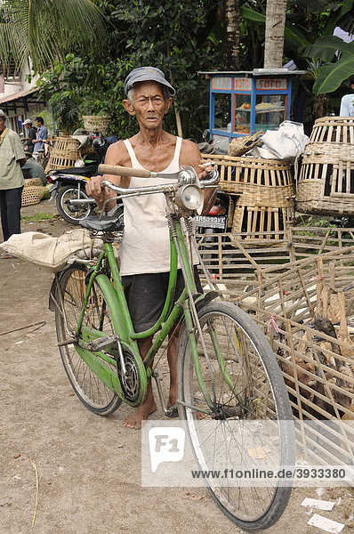 Farmer with a bicycle at the poultry market at a weekly market near Yogjakarte  Central Java  Indonesia  Southeast Asia