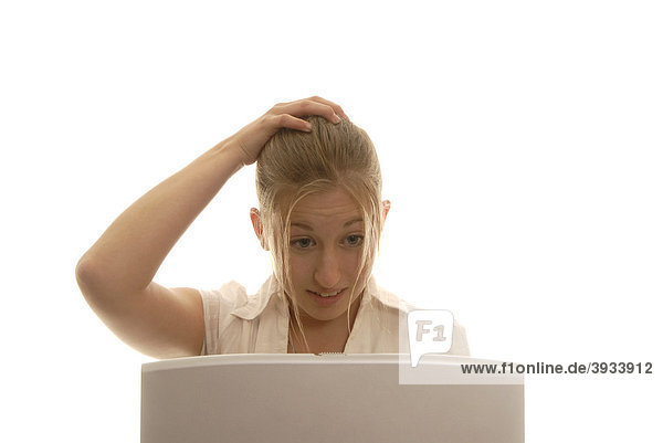 Eighteen year old woman behind a laptop  tearing her hair