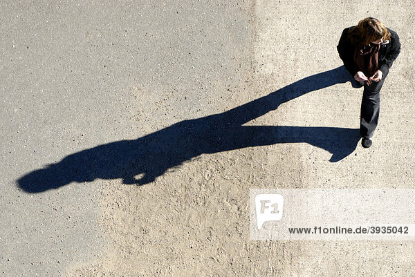 Shadow of a woman walking from a bird's-eye perspective