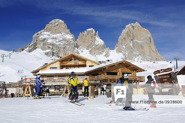 Skiers in front of the Rifugio Salei bar and restaurant  Sella Pass  Sassolungo Mountain  Sella Ronda ski trail  Val Gardena  Alto Adige  Italy  Europe