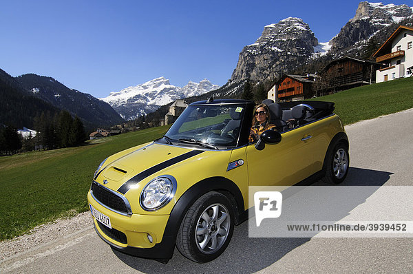 Woman driving Mini Cooper at the Gardena Pass  Alpine pass  South Tyrol  Italy  Europe