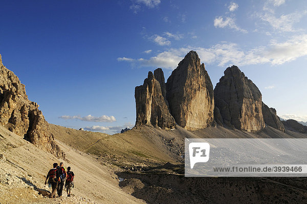 Hikers in front of the Tre Cime di Lavaredo mountains or Three Peaks  Hochpustertal  Sexten Dolomites  South Tyrol  Italy  Europe