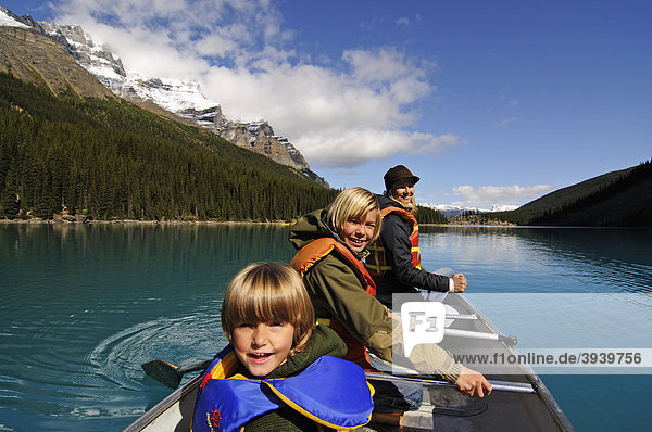 Woman and children in a canoe  Moraine Lake  Banff National Park  Alberta  Canada