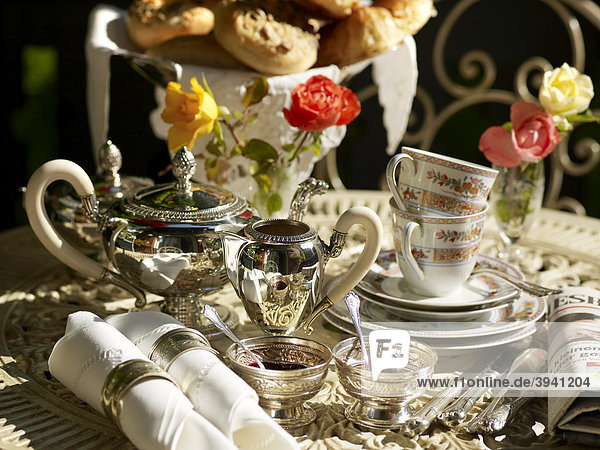 Still life  stylishly set breakfast table on a summerly balcony terrace