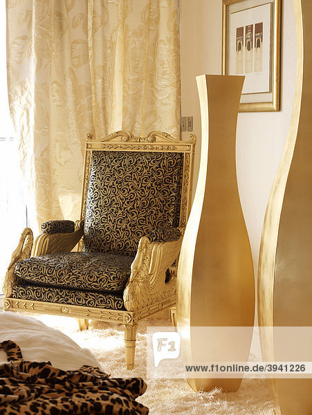 Luxurious chair and flower vase in an elegant  golden atmosphere
