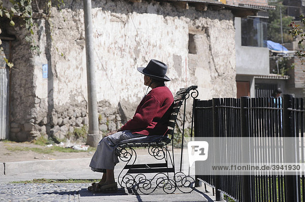 Old woman on a bench  small square  Ayacucho  Inca settlement  Quechua settlement  Peru  South America  Latin America