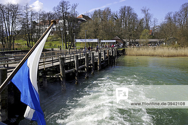 Tourists on wooden ferry boat jetty  Bavarian flag  Herreninsel  Chiemsee  Chiemgau  Upper Bavaria  Germany  Europe