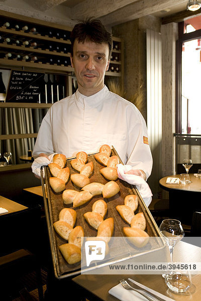 Francois Pasteau holding bread shaped like ears of wheat  head chef of L'Epi Dupin restaurant  6th Arrondissement  Paris  France  Europe