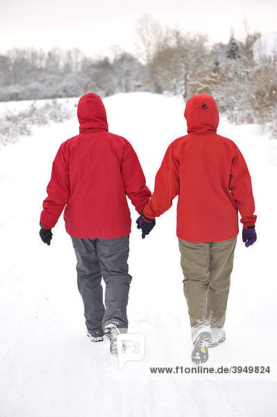 Two hikers walking through the snow