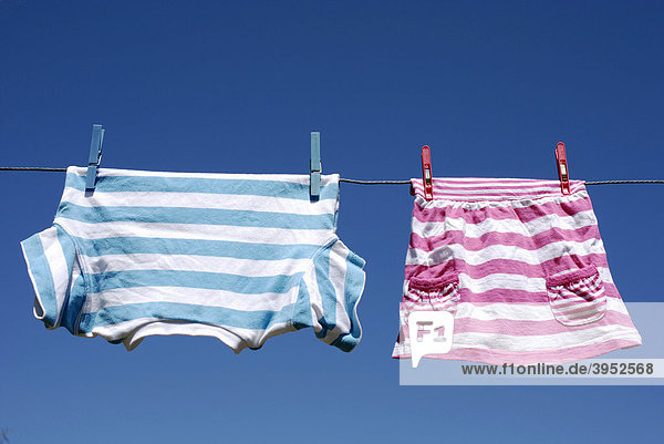 Washing line with boy's and girl's clothing
