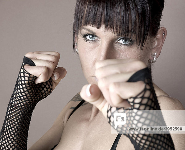 Woman  Gothic  dark-haired  balling her fists