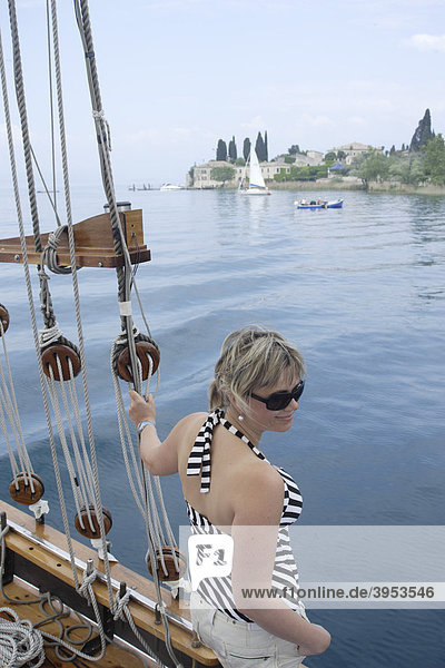 Tourist woman  San Vigilio  bay  boat trip  Lake Garda  Italy  Europe