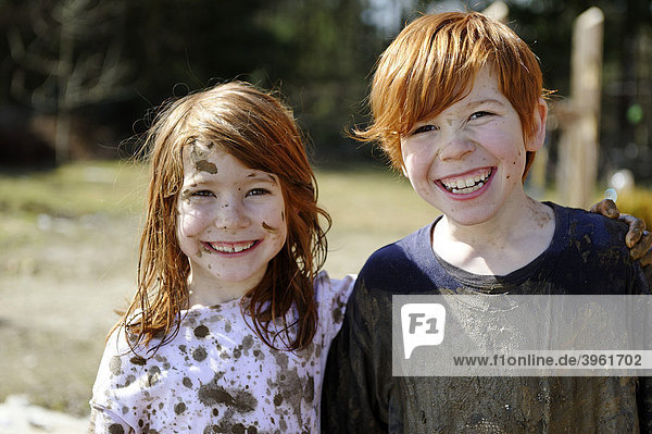 Children  totally covered in mud  dirty  wild  untypical girl