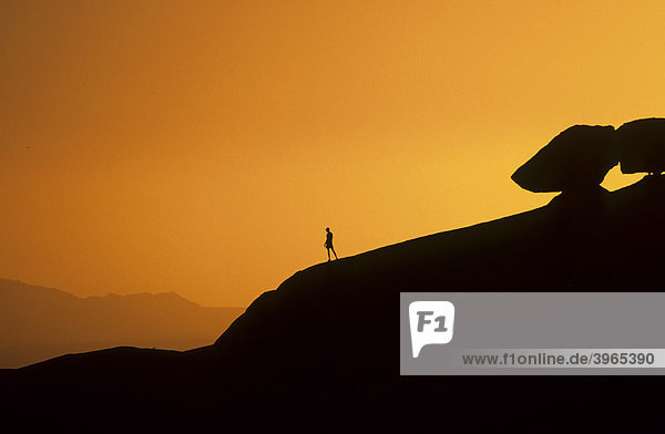Mountain hiker on the horizon  sunset  Spitzkoppe  Namibia  Africa