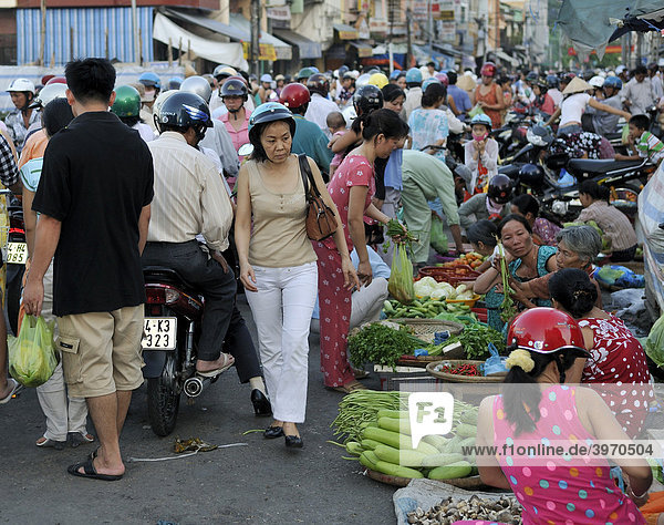Many people crowd on the road at a street market  Vinh Longh  Mekong Delta  Vietnam  Asia
