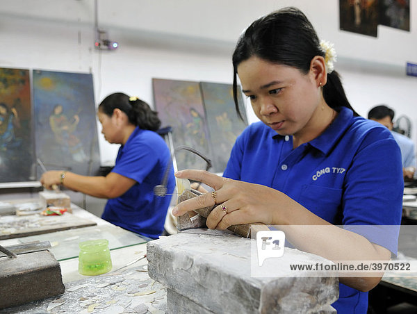 Craftswoman sawing mother of pearl  Vietnam Handicapped Handicraft Factory  Vietnam  Asia