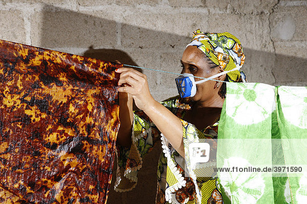 Frau mit Atemschutz stellt Stoffbatik her  Heimarbeit  Maroua  Kamerun  Afrika
