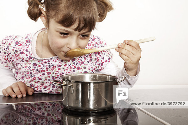Six-year-old girl playing in the kitchen