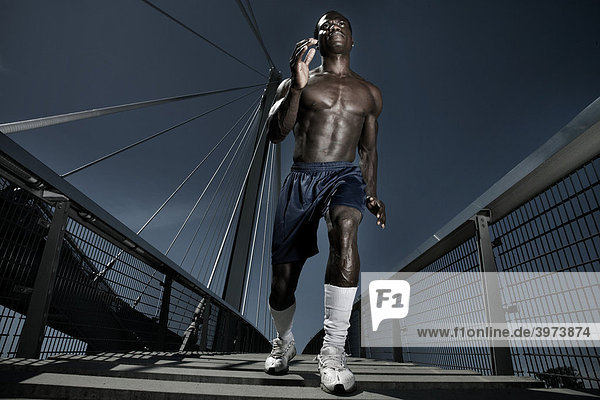 Dark-skinned athlete on a bridge