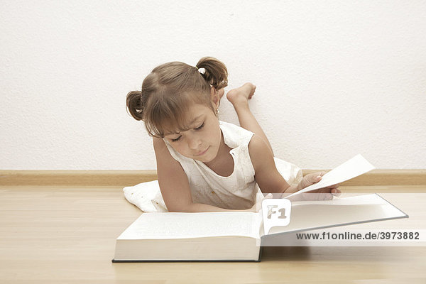 Six-year-old girl reading a book