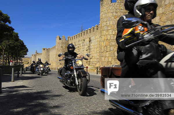 Group of motocyclists driving along the walls of Avila  Castile and LeÛn  Spain  Europe
