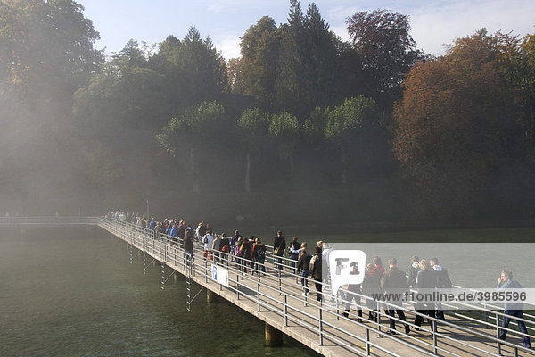 People on a jetty at the harbour  Mainau Island  slight fog  Lake Constance  Baden-Wuerttemberg  Germany