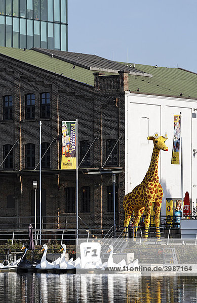 Giant giraffe made of Lego bricks eye-catcher in front of the Legoland Discovery Center inner harbor Duisburg Ruhrgebiet area North Rhine-Westphalia Germany Europe