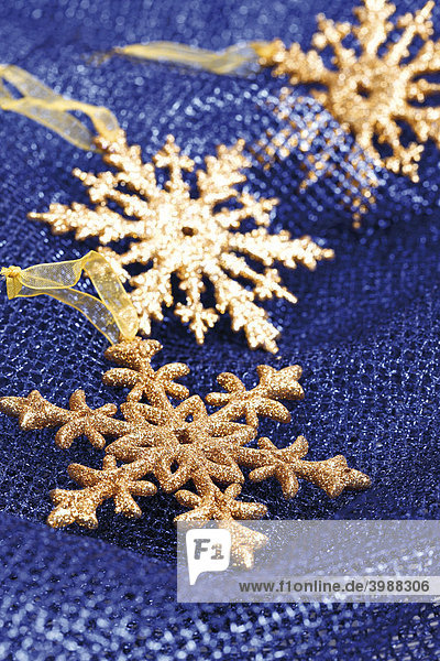 Snow crystals  snowflakes  on blue fabric  Christmas decoration