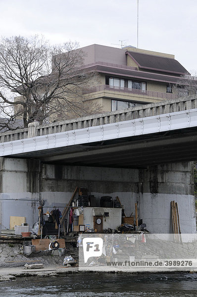Homeless person under a bridge at the river Kamo in Kyoto  Japan  Asia