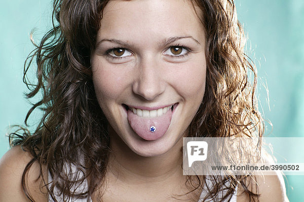Young woman with tongue piercing