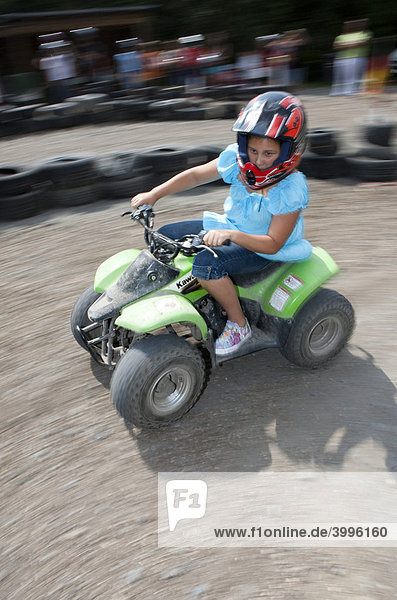 Child riding a quad bike Hesse Germany Europe