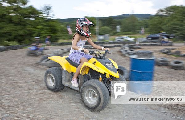 Child riding a quad bike Hesse Germany Europe