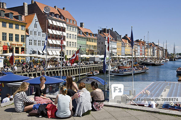 Tourists relaxing in Nyhavn  Copenhagen  Denmark